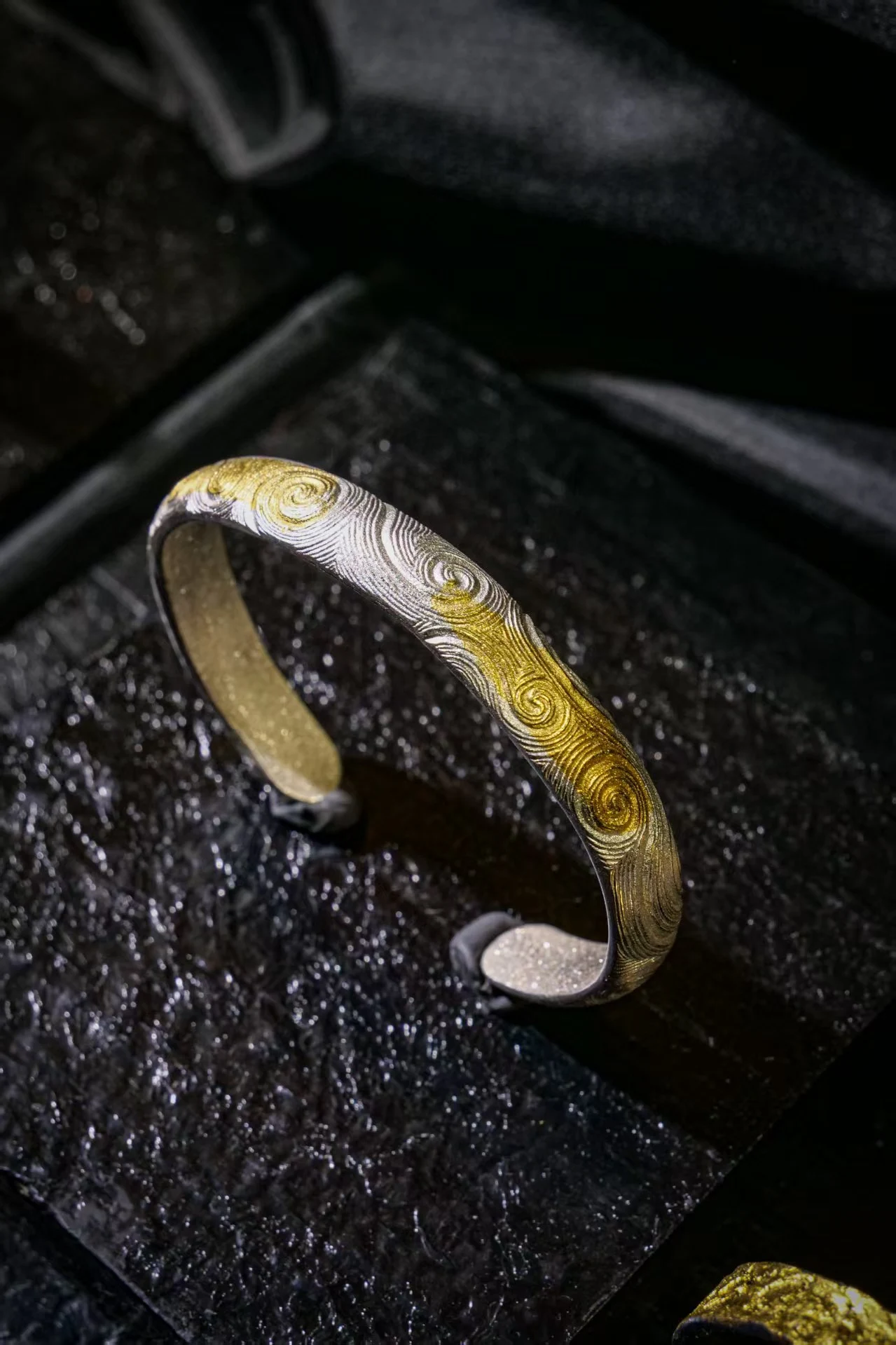Fine gold detail in an oxidized silver ring