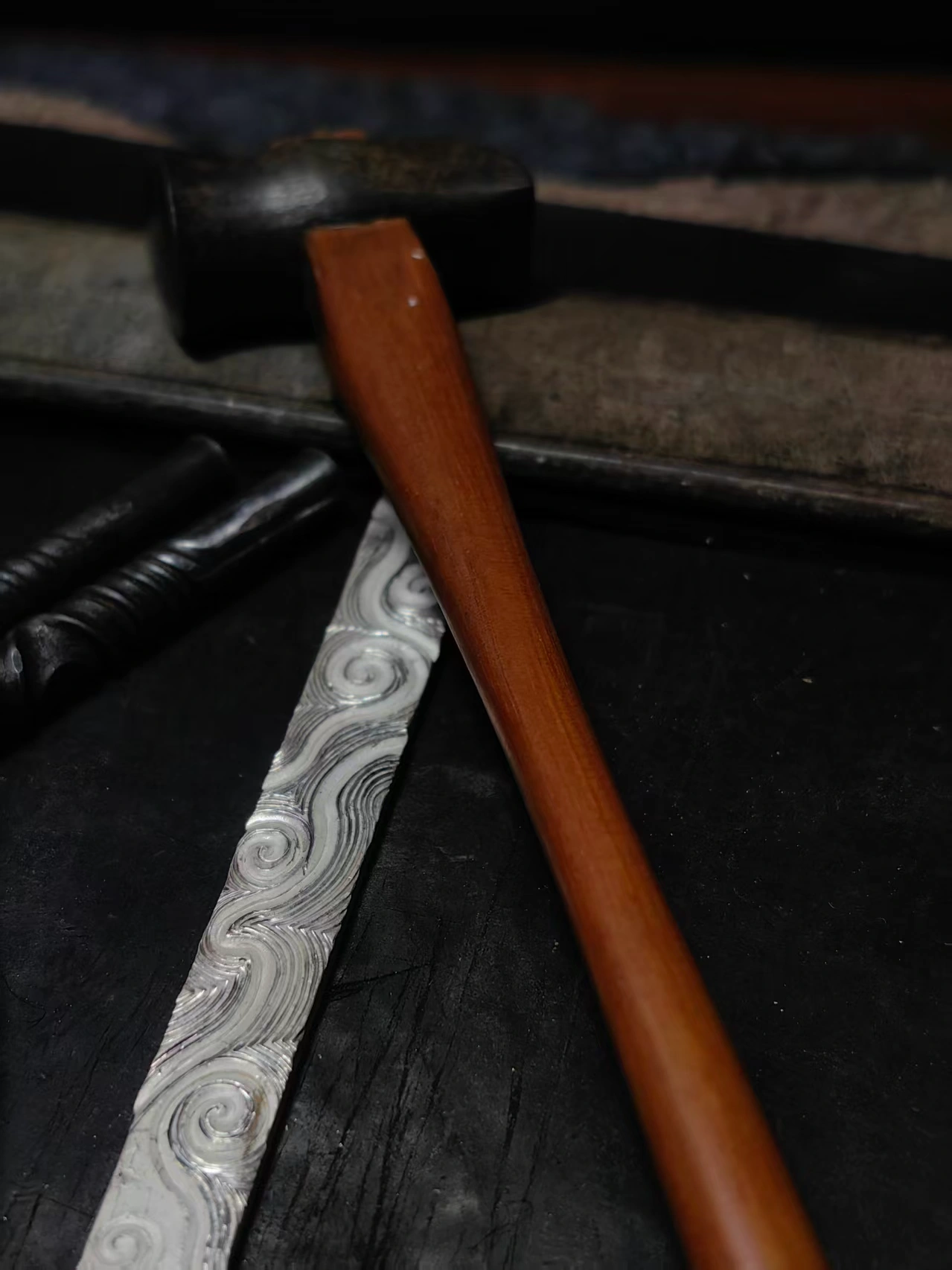 Hammer and chasing tool shaping a silver surface