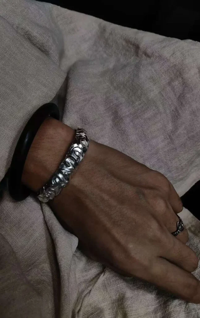 Stacked Silver Bracelets On Wrist