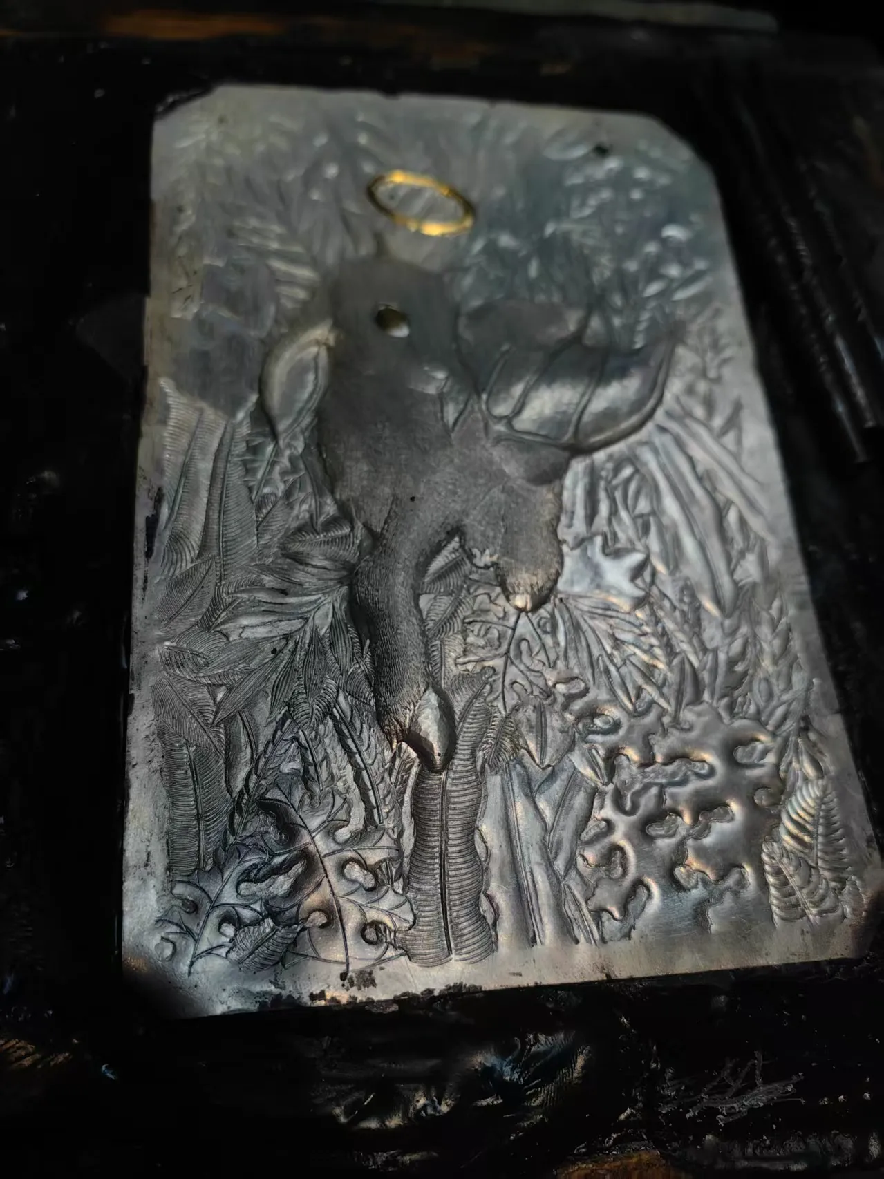 Fine lines and irregular relief on a hand-worked silver surface